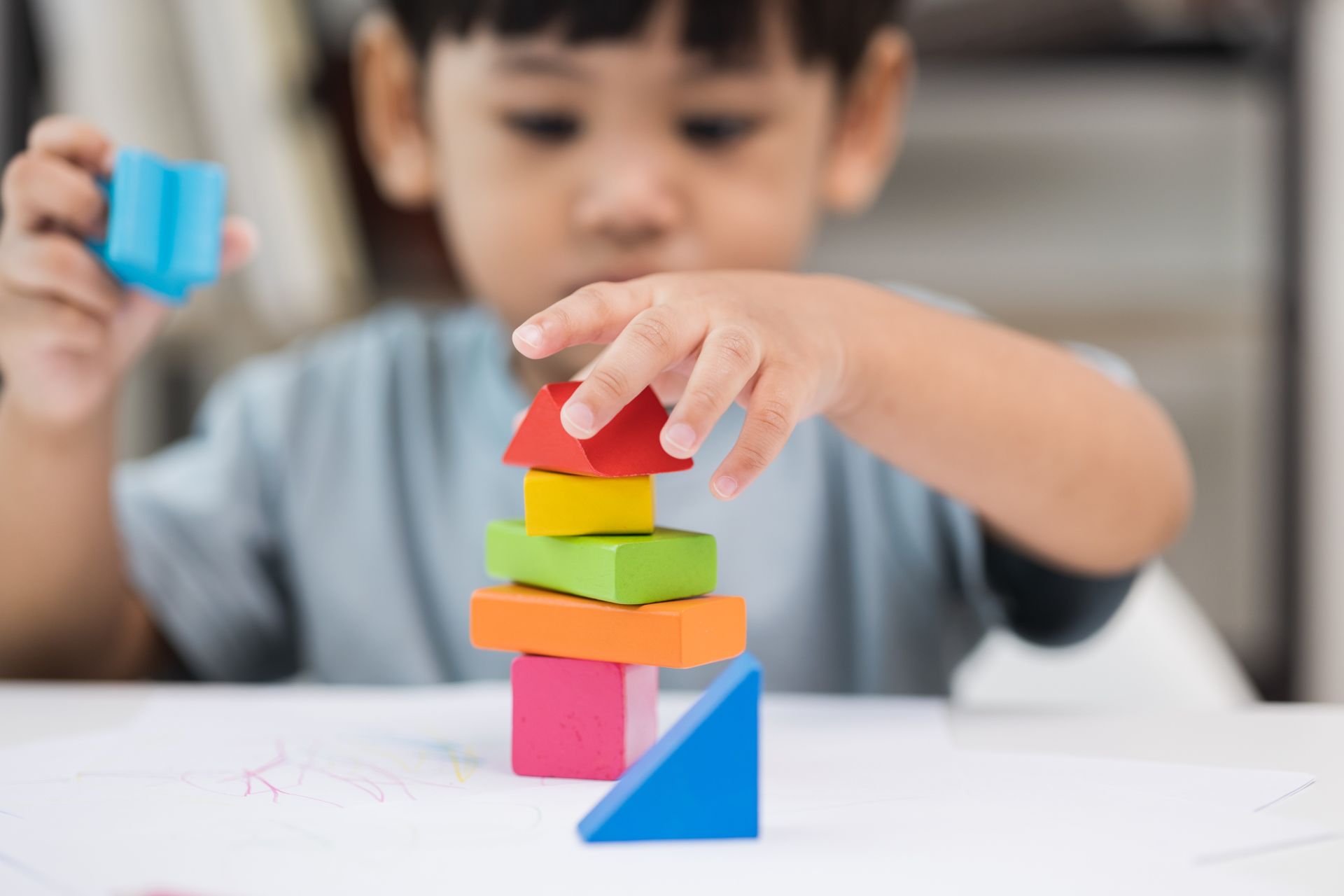 Children actively participate in a classroom with teachers, showcasing diversity and engagement.